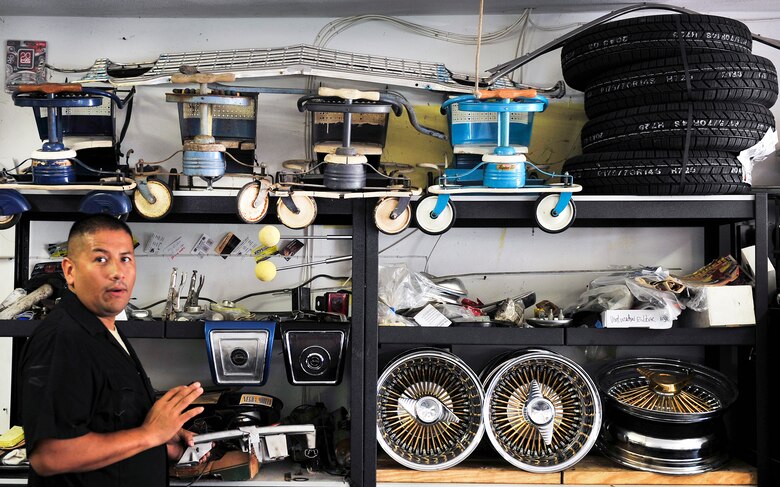 Staff Sgt. Raul Chavez shows off items he is working on and has completed in the past in his “man cave” one of which is on display, a 1960 Murray tricycle. (U.S. Air Force photo/ Staff Sgt. Stephenie Wade)