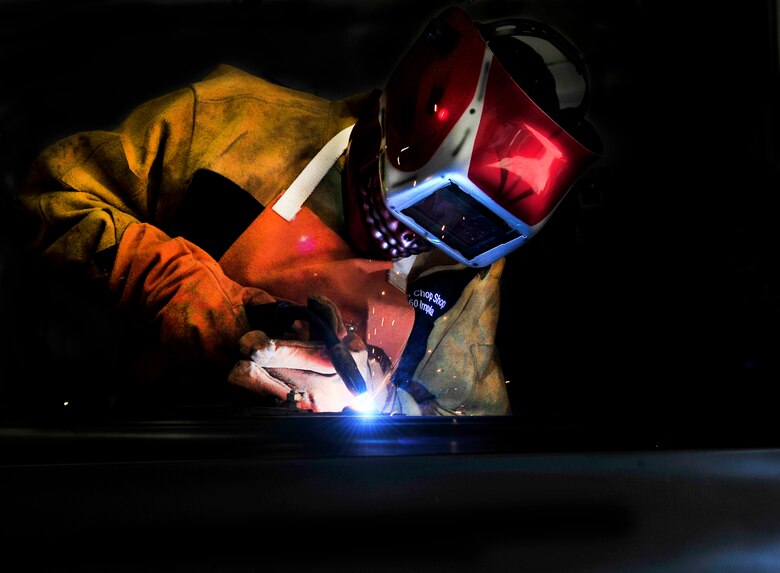 Staff Sgt. Raul Chavez is welds the door of a triple, black 1963 impala convertible with a 283 motor in his “man cave” August 30, 21012. He is building for his wife, Tech. Sgt. Alexandra Chavez. (U.S. Air Force photo/ Staff Sgt. Stephenie Wade)