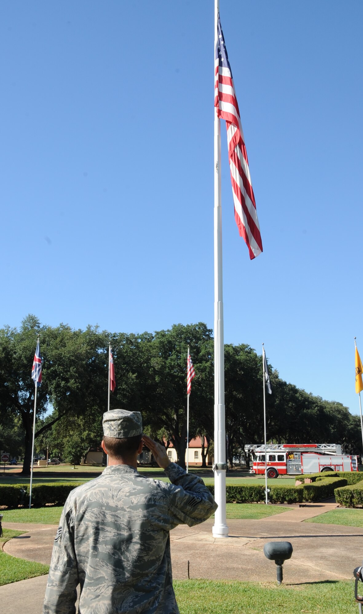 A Barksdale Airman salutes a flag flown at half-mast on Barksdale Air Force Base, La., Sept. 11. President Barack Obama signed a proclamation on Sept. 10, 2012, designating today, the 11th anniversary of the 2001, terrorist attacks on the United States as Patriot Day and a National Day of Remembrance. This was done in remembrance of those individuals who were lost during the attacks. (U.S. Air Force photo/Senior Airman Sean Martin) (RELEASED)