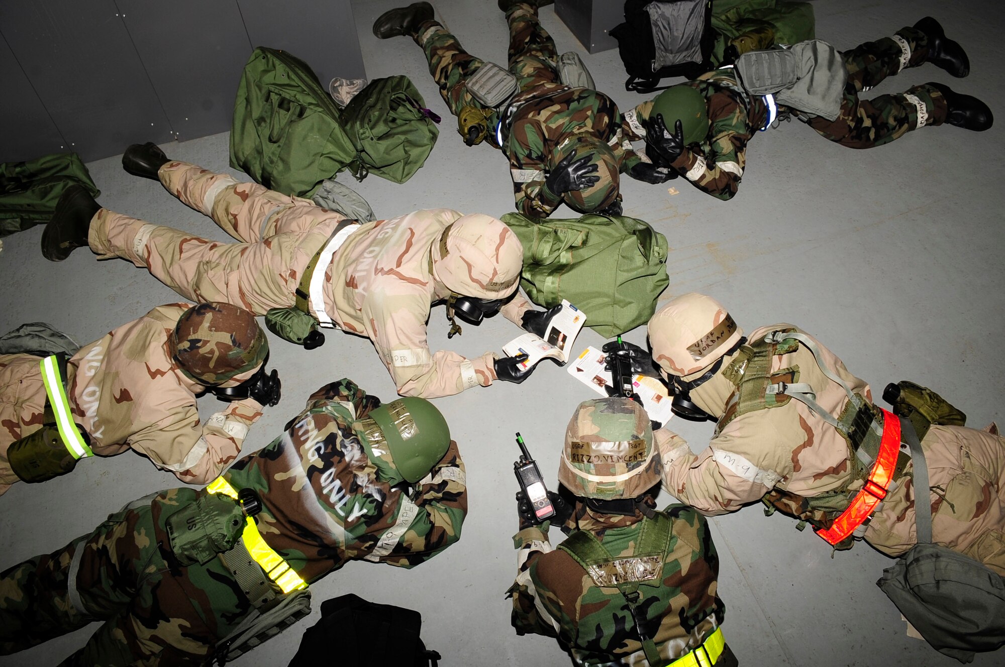 RAF MILDENHALL, England – Airmen from the 100th Civil Engineer Squadron take cover after a simulated bombing and chemical attack during an operational readiness exercise Sept. 11, 2012, at RAF Mildenhall. The ORE consisted of two phase with phase one consisting of personnel's readiness to leave and travel to the deployed location while phase two involved wartime operations and training. (U.S. Air Force photo/Senior Airman Ethan Morgan)
