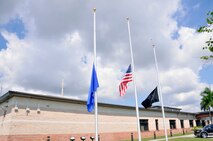 Homestead Air Reserve Base flags fly at half mass in observance of Patriot Day, an annual observance on September 11 to remember those who were injured or died during the terrorist attacks in the United States on September 11, 2001. (Air Force Photo/Senior Airman Jacob Jimenez).   