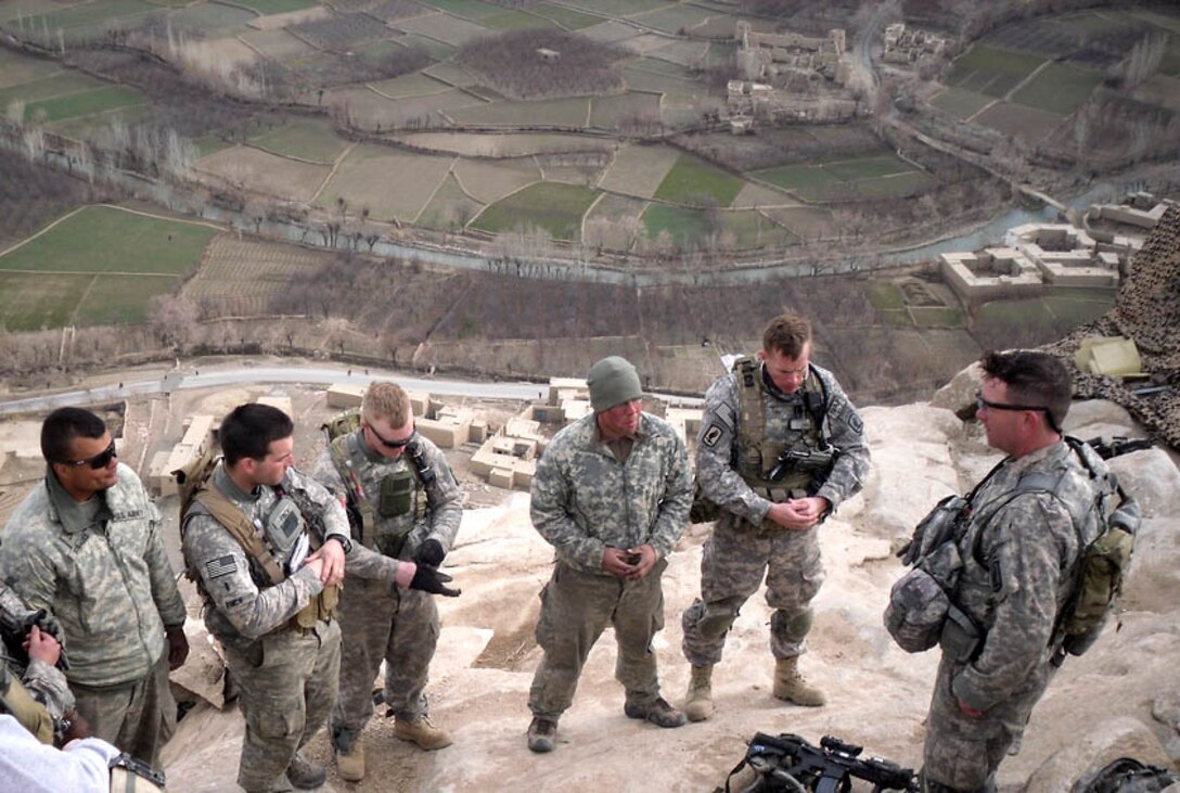 A chaplain from the 173rd Airborne Brigade Combat Team performs a communion service at an outpost overlooking the Tangi Valley in Afghanistan, recently. Chaplains are part of the Army's support system to assist Soldiers and families handle stress and combat suicide. Fort Eustis will participate in the Army-wide suicide prevention stand-down Sept. 27, and will host a variety of events tailored to increase awareness and education about suicide and ways to prevent it. (U.S. Army file photo)