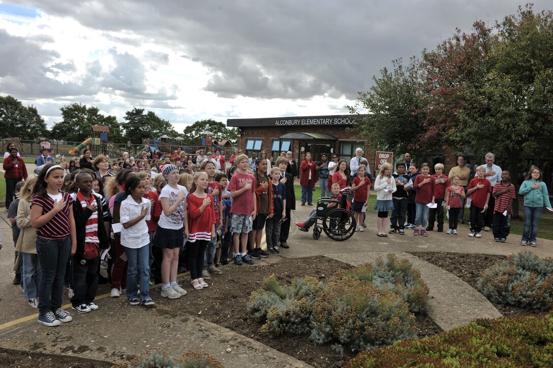 RAF ALCONBURY, United Kingdom – Children at the Alconbury Elementary School place their hands over their hearts during the playing of the National Anthem during a 9/11 ceremony at the school Sept. 11. This year marked the 11th anniversary of the attacks. (U.S. Air Force photo by Master Sgt. John Barton)