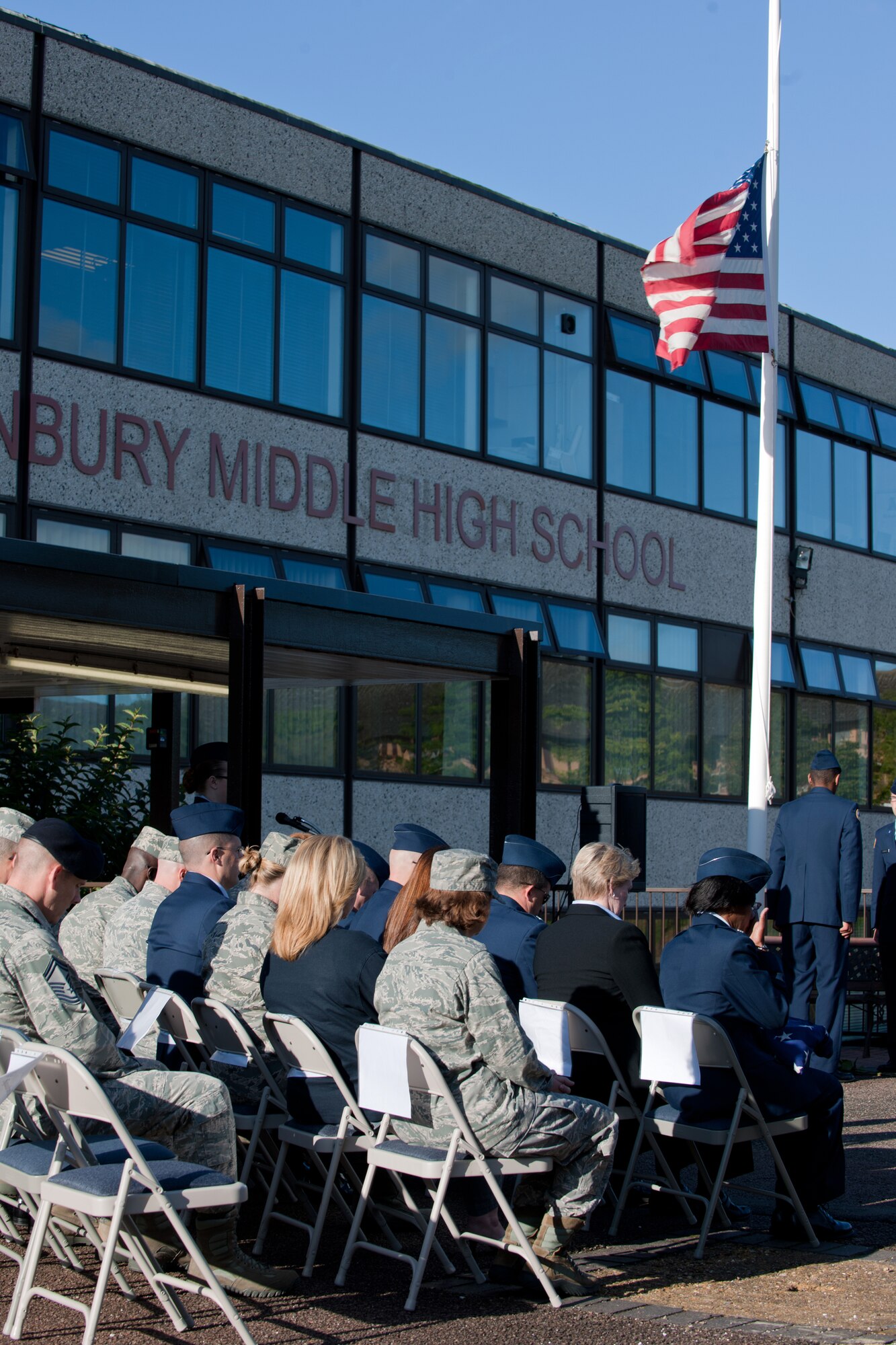 RAF ALCONBURY, United Kingdom – Members of the 501st Combat Support Wing and 423rd Air Base Group along with the Alconbury High School staff and students hold a moment of silence in remembrance during the 9/11 Remembrance Ceremony at the school flagpole Sept. 11. The school’s JROTC hosted the ceremony in honor of the 11th anniversary of the attacks. (U.S. Air Force photo by Master Sgt. John Barton)