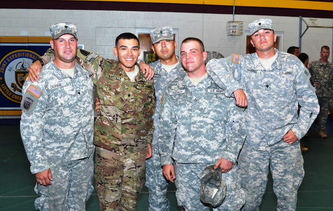 SPC Jessie Castillo, center, assigned to the119th Inland Cargo Transfer Company, 11th Transportation Battalion, 7th Sustainment Brigade, was cheerfully greeted by a group of friends within the battalion after the 119th ICTC Redeployment Ceremony held at the Fort Story gym, Sept. 6, 2012. The deployment lasted for seven months in Afghanistan. (U.S. Army Courtesy Photo/Released)