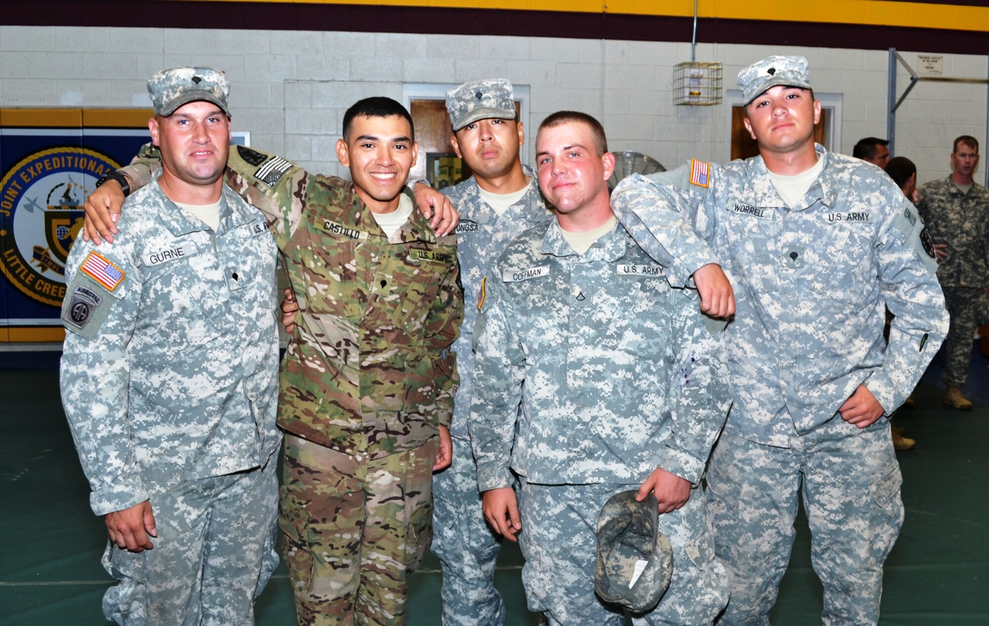 SPC Jessie Castillo, center, assigned to the119th Inland Cargo Transfer Company, 11th Transportation Battalion, 7th Sustainment Brigade, was cheerfully greeted by a group of friends within the battalion after the 119th ICTC Redeployment Ceremony held at the Fort Story gym, Sept. 6, 2012. The deployment lasted for seven months in Afghanistan. (U.S. Army Courtesy Photo/Released)