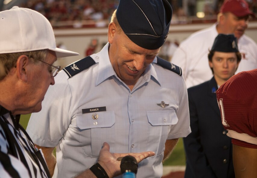 U.S. Air Force Col. Steven Ramer, 23d Wing vice commander, observes the result of a coin toss at the Lowndes County High School Military Appreciation Night at Martin Stadium in Valdosta Ga., Sept. 7, 2012. Every year Lowndes County High School holds a Military Appreciation Night when an Airman from Moody Air Force Base comes out to stand at mid field for the coin toss. (U.S. Air Force photo by Airman 1st Class Paul Francis/Released)
