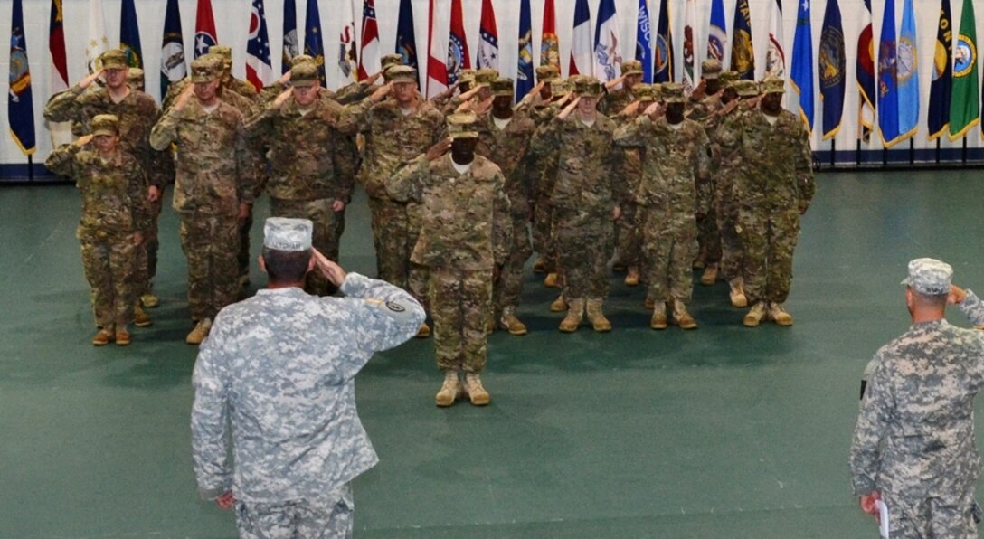 Soldiers from the 119th Inland Cargo Transfer Company, 11th Transportation Battalion, 7th Sustainment Brigade salute the flag during the playing of the National Anthem at the 119th ICTC Redeployment Ceremony held at the Fort Story gym, Sept. 6, 2012. Cpl. Mandy Burnett sang the National Anthem for the event. (U.S. Army Courtesy Photo/Released)