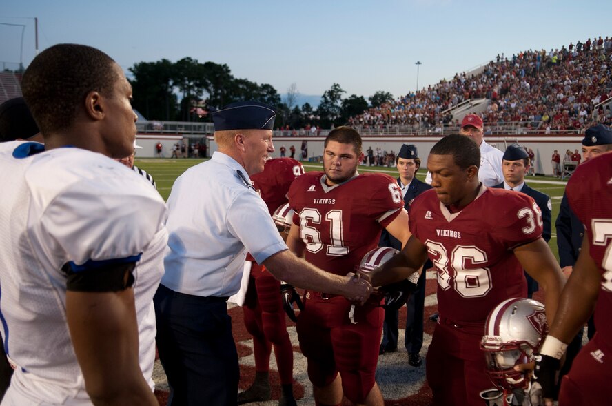 U.S. Air Force Col. Steven Ramer, 23d Wing vice commander, shakes hands with members from the Lowndes County High School Vikings football team at Martin Stadium in Valdosta Ga., Sept. 7, 2012. Ramer participated in the coin toss in recognition of Military Appreciation Night which allowed active or retired military personnel and families to enter the game free of charge. (U.S. Air Force photo by Airman 1st Class Paul Francis/Released)
