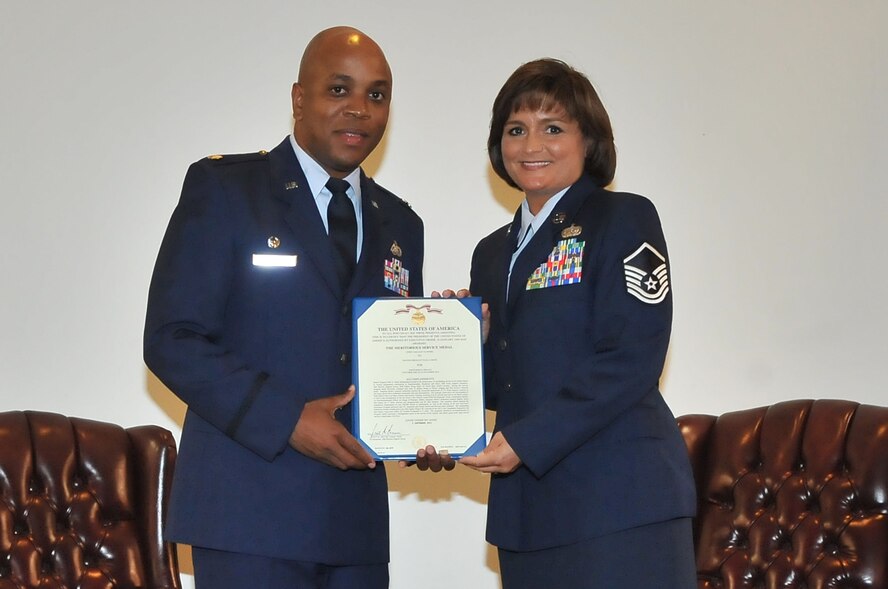 U.S. Air Force Master Sgt.  Julie Smith, 20th Force Support Squadron readiness NCOIC receives her retirement certificate from Lt. Col. Dalian Washington, 20th Force Support Squadron commander, Shaw Air Force Base, S.C., Sept.7, 2012. Retirees are presented with awards and certificates to show that their work and time in the military was appreciated	
