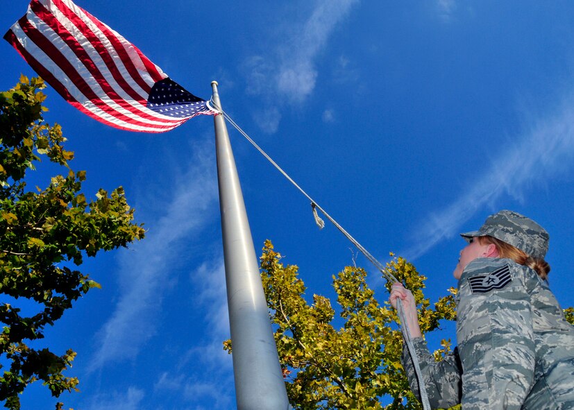 A 919th Special Operations Wing reservist lowers the flag to half staff in front of the wing headquarters building Sept. 11, 2012 at Duke Field , Fla., joining the nation's memorial to the victims of the 9/11 attacks on America.  Shortly after the attacks, the Air Force Reserve's most decorated wing began deploying for more than 10 continuous years of combat support in the U.S. military's overall response to those terrorist acts.  (U.S. Air Force photo/Tech. Sgt. Cheryl Foster)
