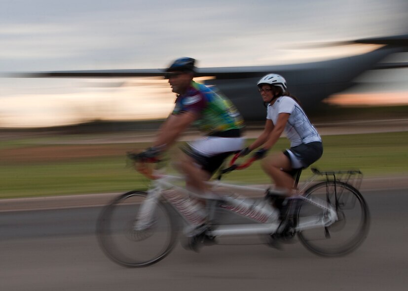 Cyclists ride their tandem bike down Louisiana Road Sept. 8, 2012, during Le Tour De Dyess at Dyess Air Force Base, Texas. The race began at the fitness center and weaved 26-miles throughout Dyess. (U.S. Air Force photo by Airman 1st Class Damon Kasberg/Released)