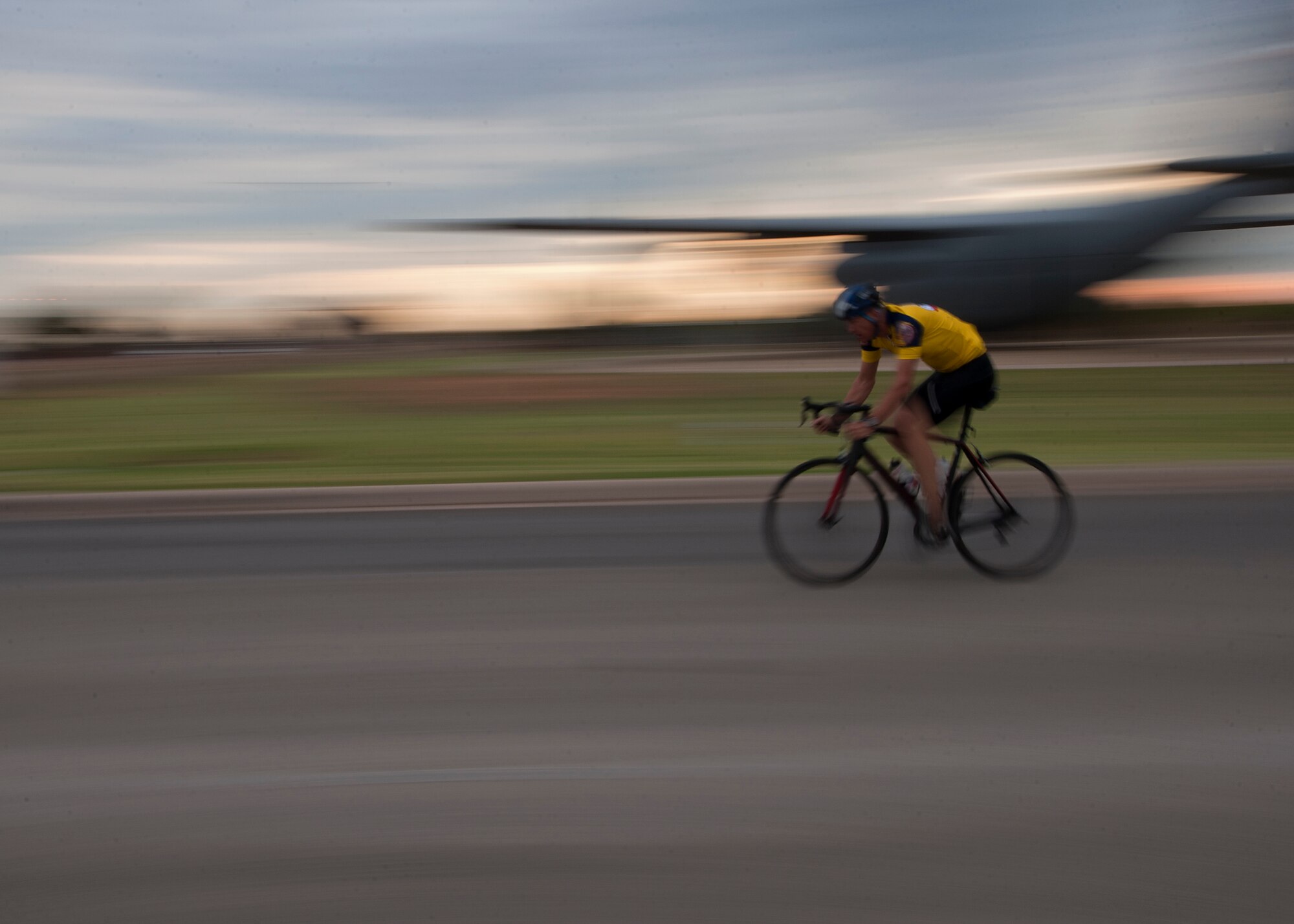 A cyclist rides down Louisiana Road Sept. 8, 2012, during Le Tour De Dyess at Dyess Air Force Base, Texas. The race began at the fitness center and weaved 26-miles throughout Dyess. (U.S. Air Force photo by Airman 1st Class Damon Kasberg/Released)