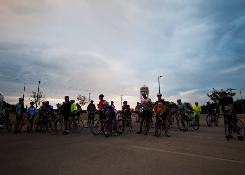 Participants gather in front of the fitness center Sept. 8, 2012, before the second annual Le Tour De Dyess at Dyess Air Force Base, Texas. The race began at the fitness center and weaved 26-miles throughout Dyess. (U.S. Air Force photo by Airman 1st Class Damon Kasberg/Released)