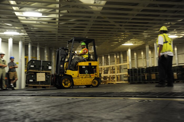 A dock worker move ammunition and supplies from Joint Base Charleston-Weapons Station to Military Sealift United States Navy Ship Lewis and Clark (T-AKE-1), Dry cargo/Ammunition Ship, during an ammunition onload recently at JB Charleston-Weapons Station.  More than 1700 pallets were received by USNS Ship Lewis and Clark during the onload.  It had been sixteen years since a ship has been pre-positioned at Joint Base Charleston-Weapons Station. (U.S. Air Force photo by Staff Sgt. Rasheen A. Douglas)