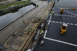 Dock workers move ammunition and supplies from Joint Base Charleston - Weapons Station to the USNS Lewis and Clark (T-AKE-1), during a recent ammunition onload at JB Charleston - Weapons Station, S.C.  More than 1,700 pallets were loaded onto the ship. This was the first onload of a Military Sealift Command pre-positioning  vessel at Joint Base Charleston - Weapons Station in 16 years. (U.S. Air Force photo/Staff Sgt. Rasheen  Douglas)