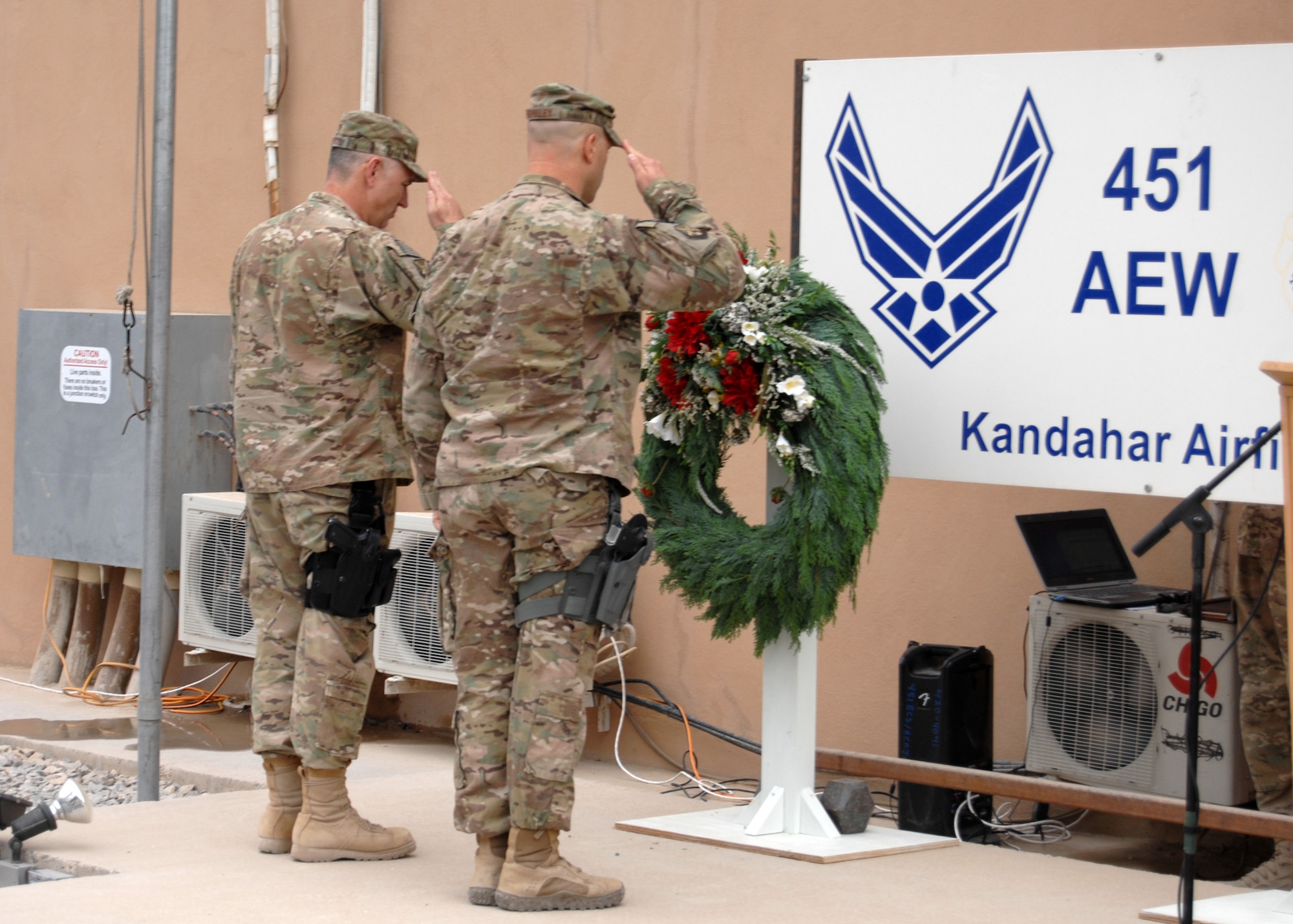 U.S. Air Force Brig. Gen. Scott Dennis (left), 451st Air Expeditionary Wing and Kandahar Airfield (NATO) commander, and Chief Master Sgt. David Brinkley, 451st AEW command chief, lay a wreath honoring the lives lost at the World Trade Center in New York City, Sept. 11, 2001, in a memorial ceremony here today. The ceremony marked the 11-year anniversary of the tragedy. (U.S. Air Force photo/Master Sgt. Russell Martin)
