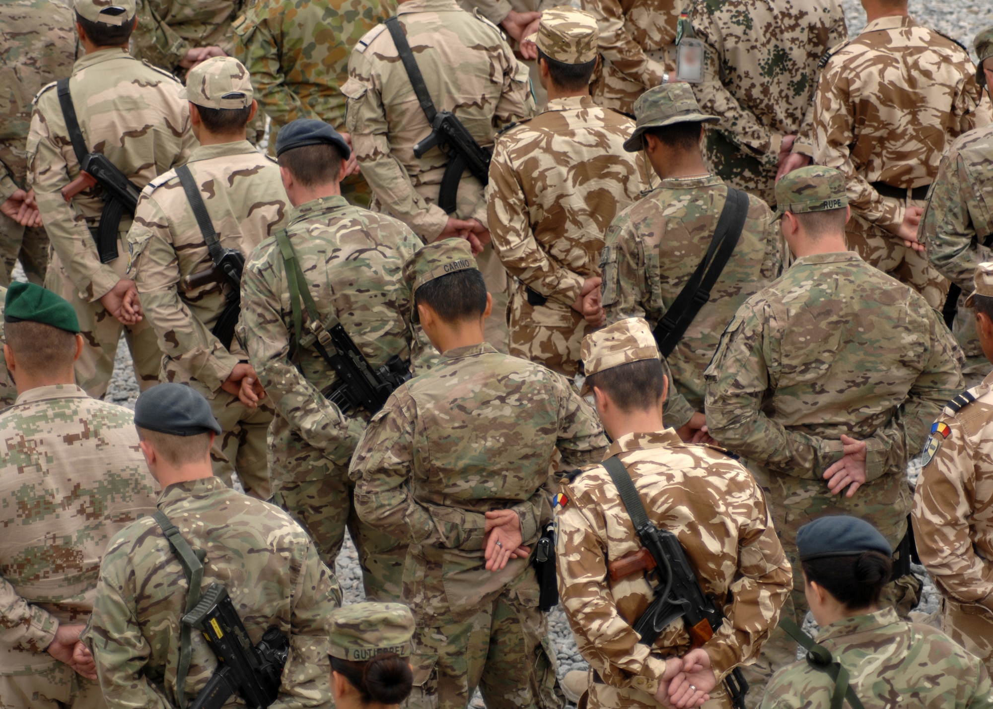 U.S. and coalition forces bow their heads during the benediction as part of the 9/11 Memorial Ceremony held here today. Kandahar is home to nearly 30,000 coalition members from nearly 40 nations. (U.S. Air Force photo/Master Sgt. Russell Martin)