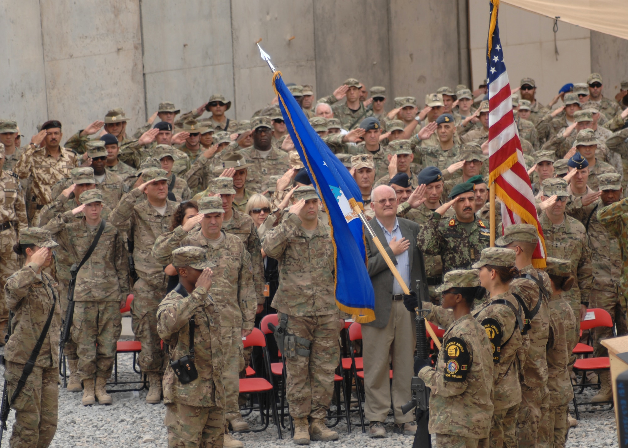 Deployed U.S. Airmen, Soldiers, Sailors, Marines and service members from coalition forces render honors during the playing of the National Anthem during the 9/11 Memorial Ceremony held here today. More than 200 U.S. and coalition forces joined together to observe the event. (U.S. Air Force photo/Master Sgt. Russell Martin)