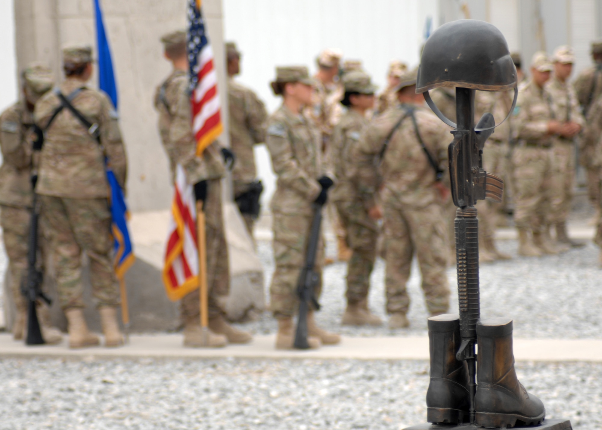 The bronze memorial remembering Airman 1st Class Raymond Losano, who lost his life April 23, 2003 during the early days of Operation Enduring Freedom, stands as a backdrop to the day’s 9/11 Memorial Ceremony here. (U.S. Air Force photo/Master Sgt. Russell Martin)