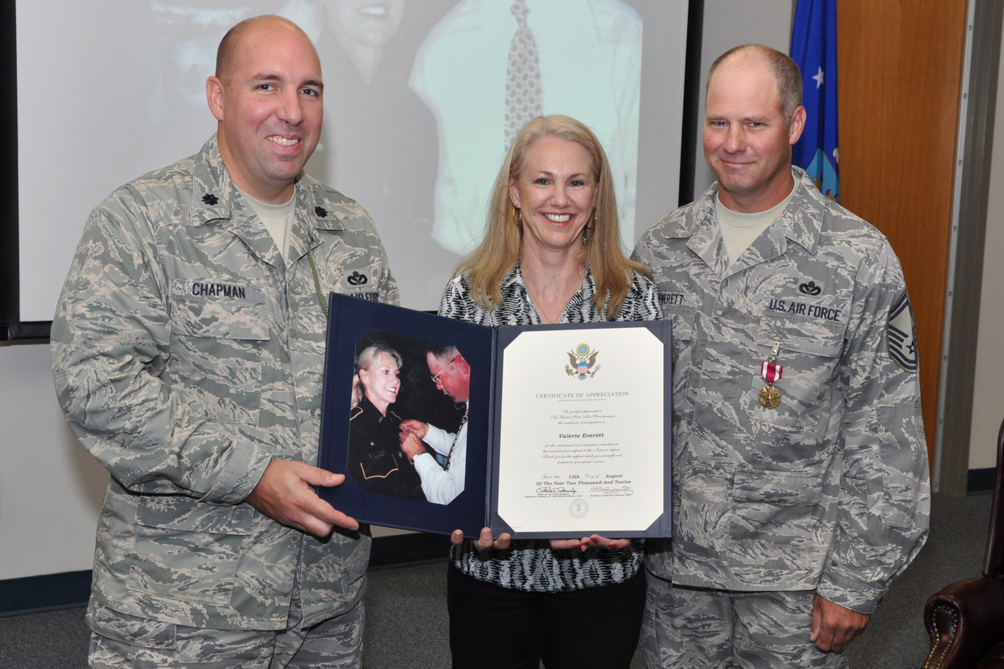 Lt. Col. Charles B. Chapman III, commander of the 307th Civil Engineer Squadron, Valerie Everett and Retired Senior Master Sgt. Charles F. Everett IV, pose for a photo during a retirement ceremony after Valerie receives a certificate of appreciation at Barksdale Air Force Base, La., Sept. 9, 2012. Chapman was the presiding official for the ceremony in which Charles Everett retired from the Air Force. (U.S. Air Force photo by Master Sgt. Jeff Walston/Released)