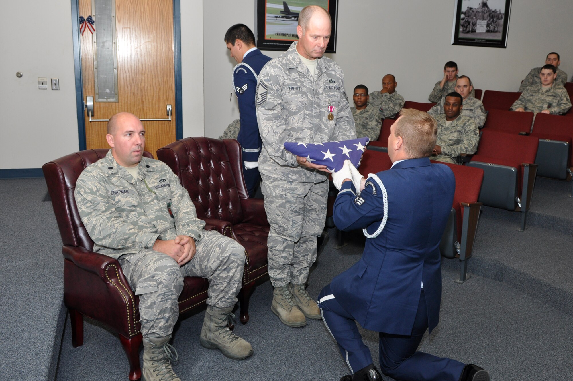 A member of the Base Honor Guard presents a flag to Retired Senior Master Sgt. Charles F. Everett IV during his retirement ceremony at Barksdale Air Force Base, La., Sept. 8, 2012. Lt. Col. Charles B. Chapman III, commander of the 307th Civil Engineer Squadron was the presiding official for the ceremony. (U.S. Air Force photo by Master Sgt. Jeff Walston/Released)