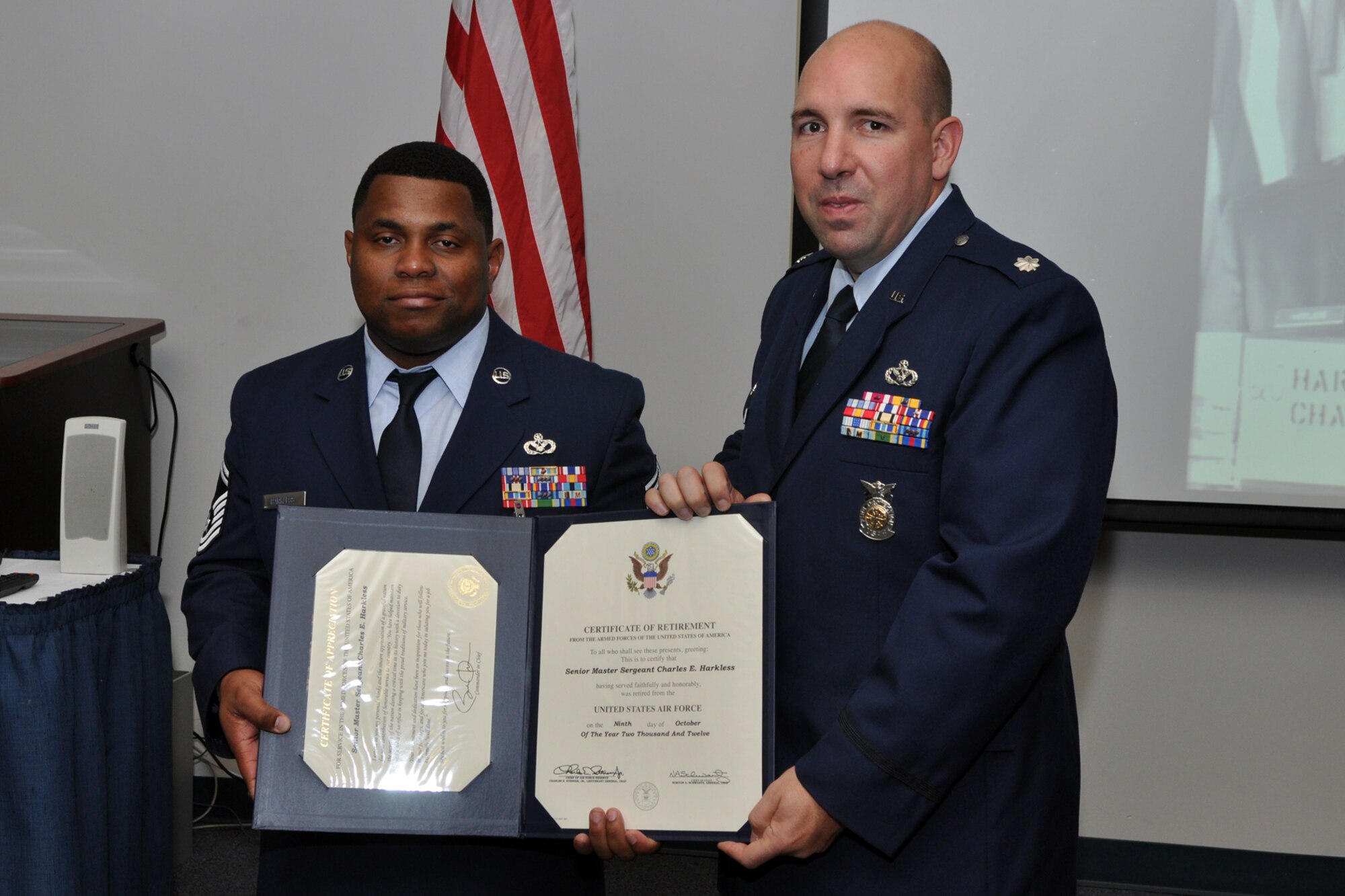 Retired Senior Master Sgt. Charles E. Harkless Jr., and Lt. Col. Charles B. Chapman III pose for a photo during a retirement ceremony at Barksdale Air Force Base, La., Sept. 8, 2012. Chapman was the presiding official for the ceremony. (U.S. Air Force photo by Master Sgt. Jeff Walston/Released)