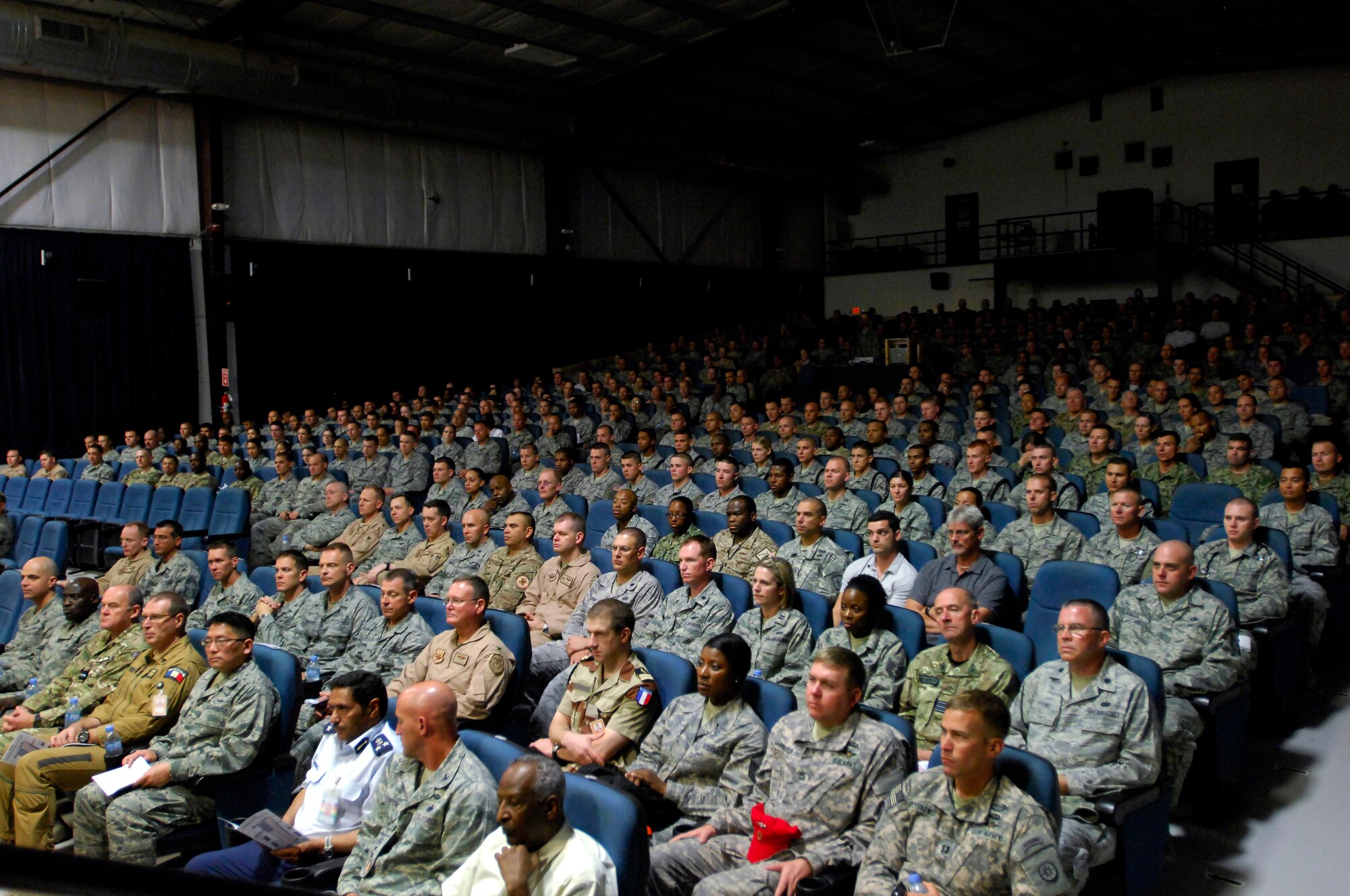 Audience members listens to the first responders (medical, security forces, and fire services) honor the fallen with meditations distinctive of their corps during the 9/11 Commemoration Ceremony in Southwest Asia, September 11, 2012. The Grand Slam Wing observed the 11th anniversary of the Sept. 11, 2001 attack to honor and remember those who lost their lives at the World Trade Center, the Pentagon, the fields of Shanksville, Penn., and on the battlegrounds of Iraq and Afghanistan. (U.S. Air Force photo/Staff Sgt. Sheila deVera)