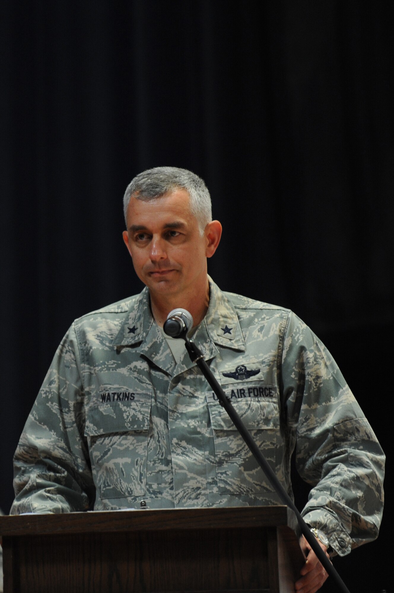U.S. Air Force Brig. Gen. Roger Watkins, 379th Air Expeditionary Wing commander, speaks to the audience during the 9/11 Commemoration Ceremony in Southwest Asia, September 11, 2012. The Grand Slam Wing observed the 11th anniversary of the Sept. 11, 2001 attack to honor and remember those who lost their lives at the World Trade Center, the Pentagon, the fields of Shanksville, Penn., and on the battlegrounds of Iraq and Afghanistan. (U.S. Air Force photo/Staff Sgt. Sheila deVera)