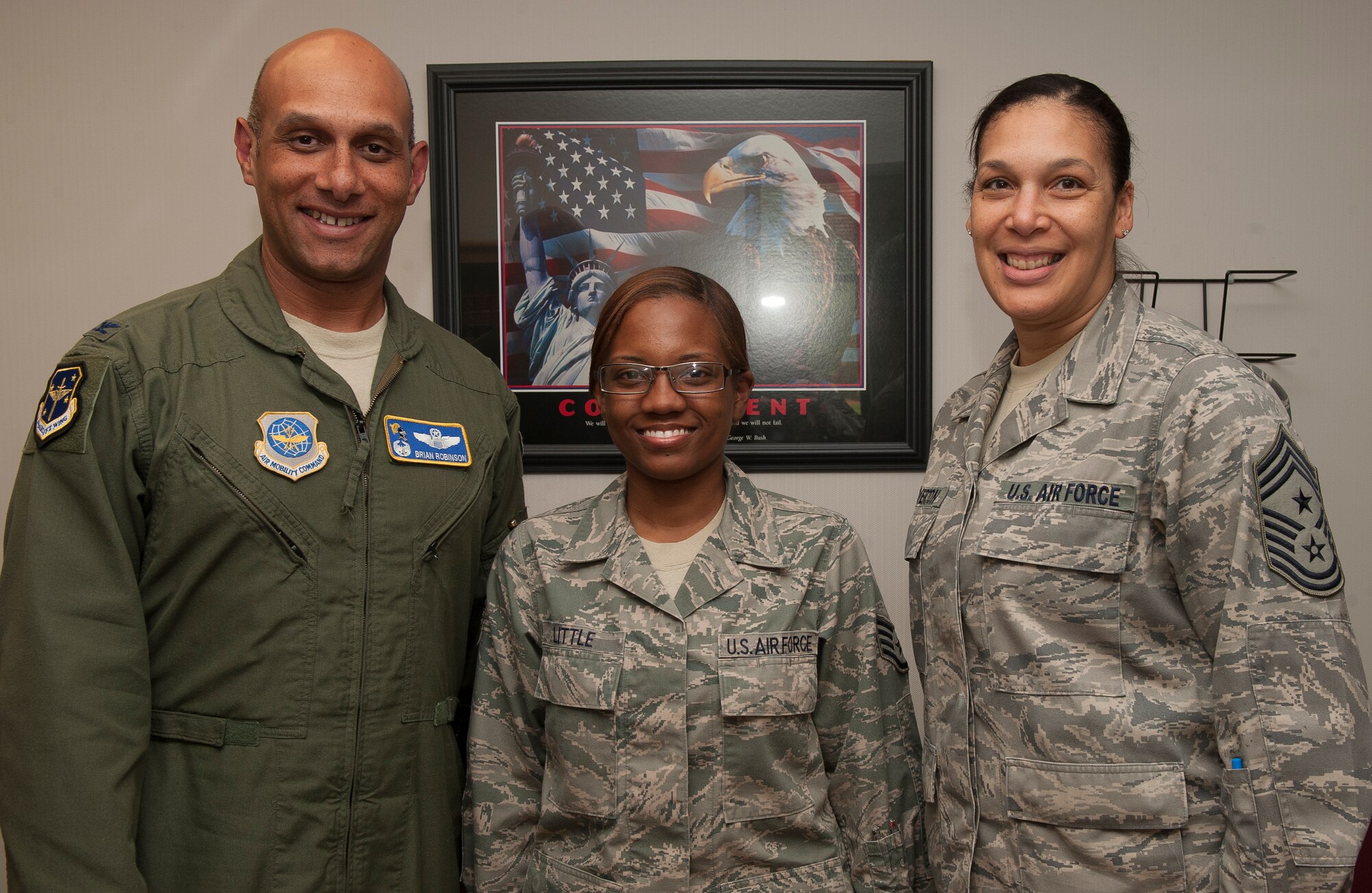 Col. Brian Robinson, 19th Airlift Wing commander, and Chief Master Sgt. Margarita Overton, 19th Airlift Wing command chief, congratulate Staff Sgt. Charvell Little, a paralegal with the Area Defense Counsel, for her selection as Combat Airlifter of the Week on Sept. 4, 2012. Charvell, a native of Minneapolis, Minn., runs all of the administrative functions in the two person deep office.  (U.S. Air Force photo by Staff Sgt. Russ Scalf)
