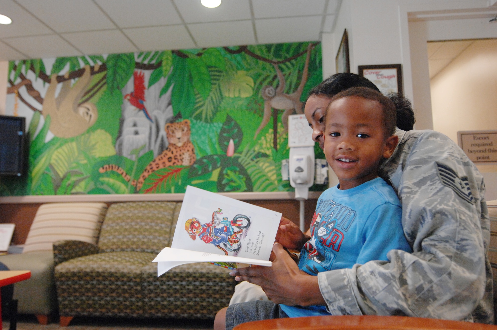 Calvin Wofford Jr. and his mother read a book while in the waiting room at pediatric services, Shaw Air Force Base, S.C., Sept. 5, 2012.  The pediatrics clinic has been at Shaw for 14 years and its staff consists of six enlisted personnel, three officers and one civilian. (U.S. Air Force photo by Airman Nicole Sikorski/Released)