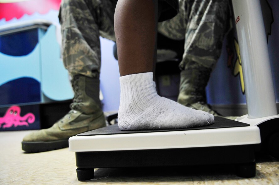U.S. Air Force Airman 1st Class Bryant Wilson, 20th Medical Group medical technician, weighs Calvin Wofford Jr. at Shaw Air Force Base, S.C., Sept. 5, 2012.  The pediatrics clinic has been at Shaw for 14 years and its staff consists of six enlisted personnel, three officers and one civilian. (U.S. Air Force photo by Airman Nicole Sikorski/Released)