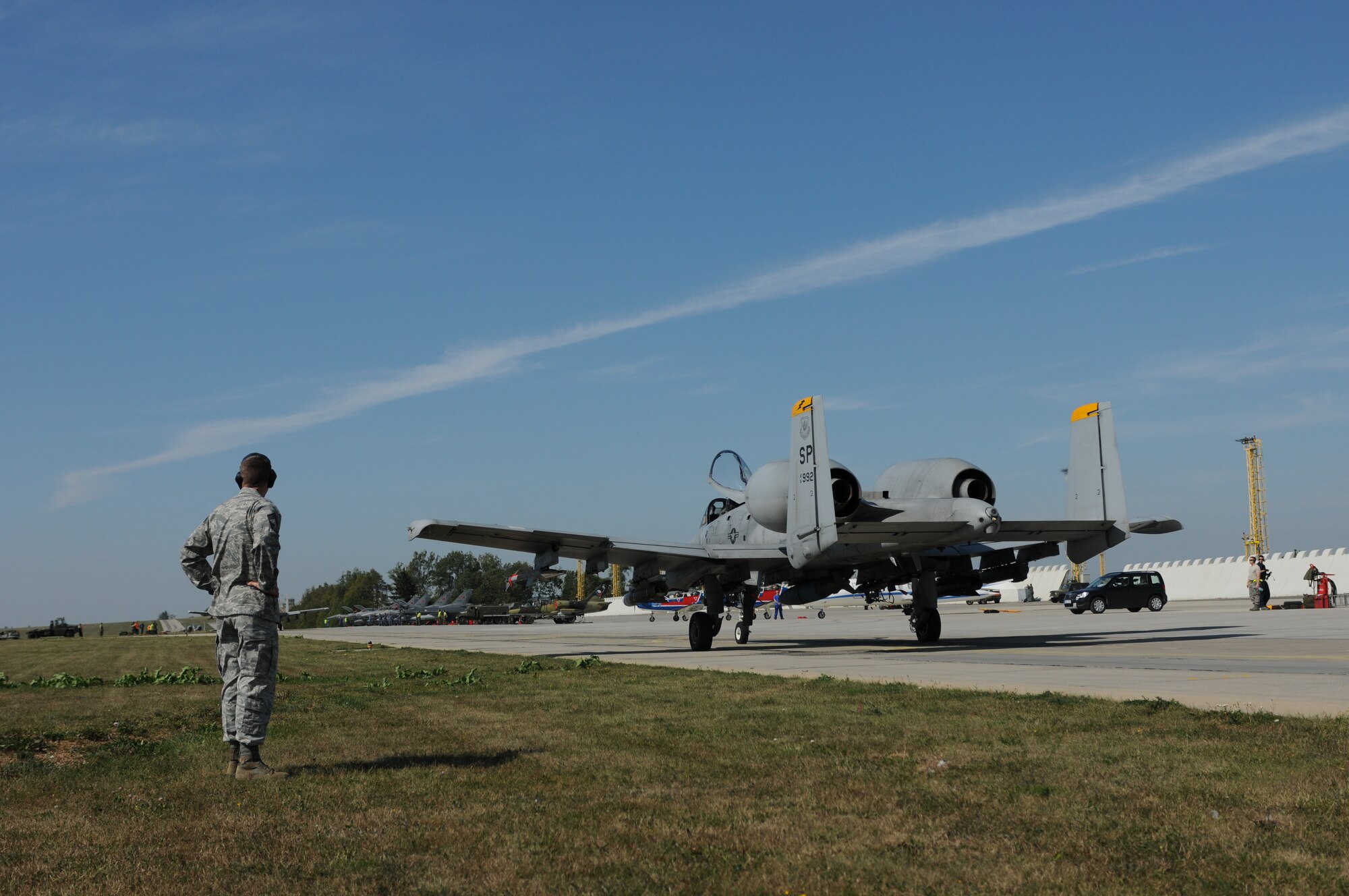 NAMEST AIR BASE, Czech Republic -- An Airman from the 81st Fighter Squadron looks on as an A-10 Thunderbolt II taxis down the runway before taking off for a close air support and forward air control training mission Sept. 10, during Ramstein Rover 2012 here. RARO 12 is a NATO partnership building exercise involving more than 16 nations. A-10 Thunderbolt IIs from the 81st FS are participating in the exercise to provide close air support to partnering nations and practice forward air control missions with their NATO allies in international security assistance force realistic scenarios. During this mission the 81st FS pilots supported German and Italian forward air controllers. Participating in exercises like RARO 12 ensures effective employment of airpower in support of alliance or coalition forces while mitigating risks to civilians in contingency operations. (U.S. Air Force photo by Senior Airman Natasha Stannard/Released)