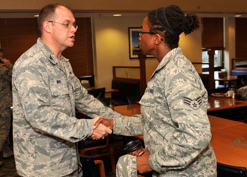 Col. Richard Moore, commander of the 436th Airlift Wing, greets Senior Airman Monika Giacchino of the 436th Logistics Readiness Squadron Sep. 6, 2012, at the Dining Facility on Dover Air Force Base, Del. Col. Moore had breakfast with Airmen to seek out their thoughts and concerns about the base and the Air Force. (U.S. Air Force photo by Tech. Sgt. Chuck Walker)