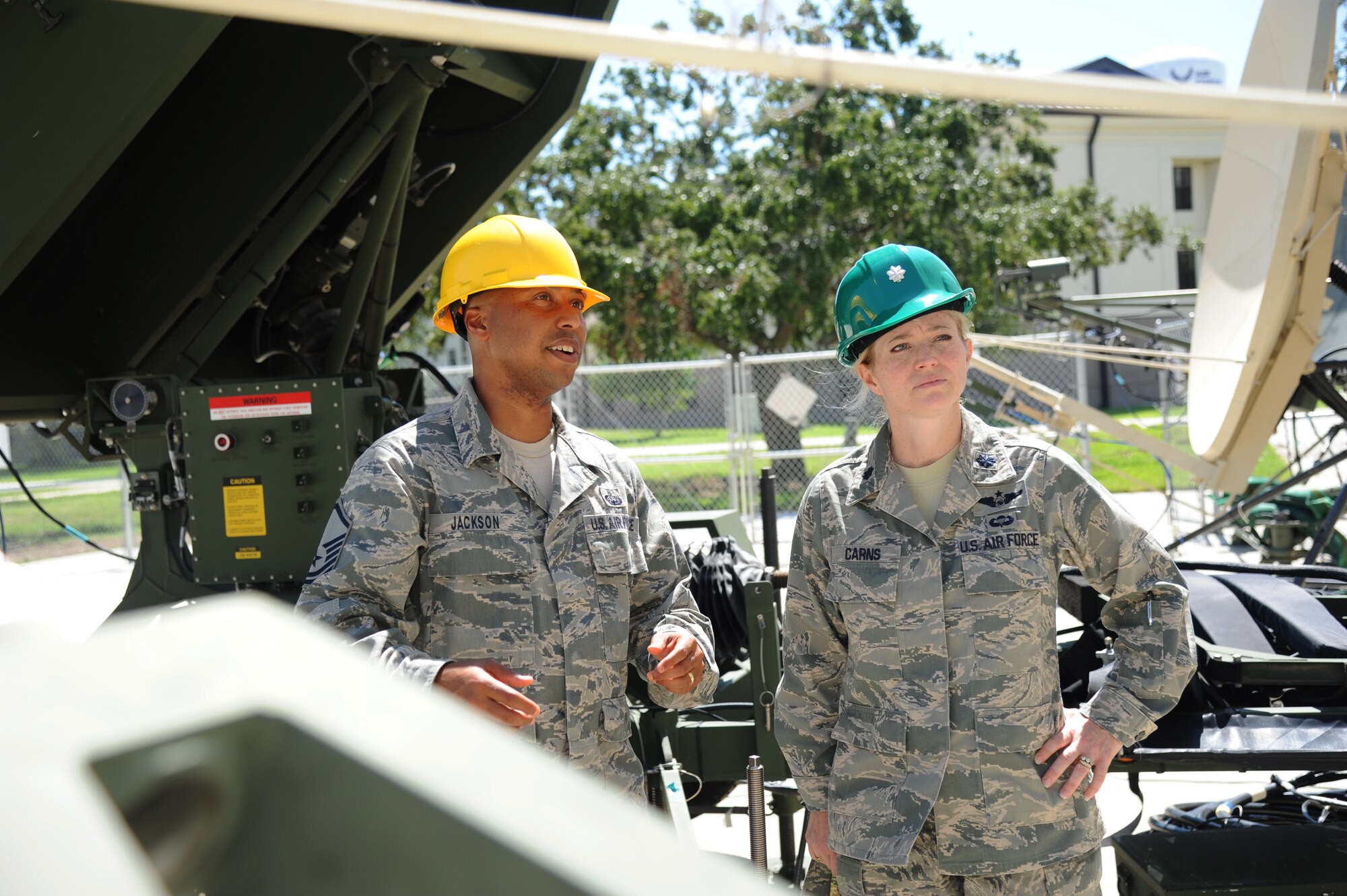 Master Sgt. Albrecco Jackson, 338th Training Squadron instructor supervisor, provides a tour of the radio frequency transmissions systems course equipment to Lt. Col. Michelle Carns, 338th TRS commander, Sept. 7, 2012, outside of Jones Hall, Keesler Air Force Base, Miss.  (U.S. Air Force photo by Kemberly Groue)