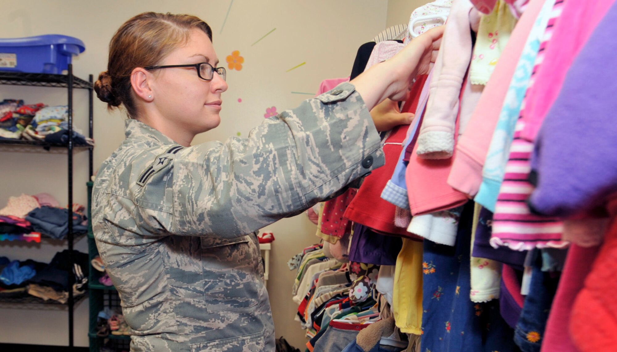 Airman 1st Class Rachel Simmons sorts through children's clothing Sep. 6, 2012, at the Airmen's Attic on Dover Air Force Base, Del. Simmons is the Airman Coordinator for the Airmen's Attic. (U.S. Air Force photo by Tech. Sgt. Chuck Walker)