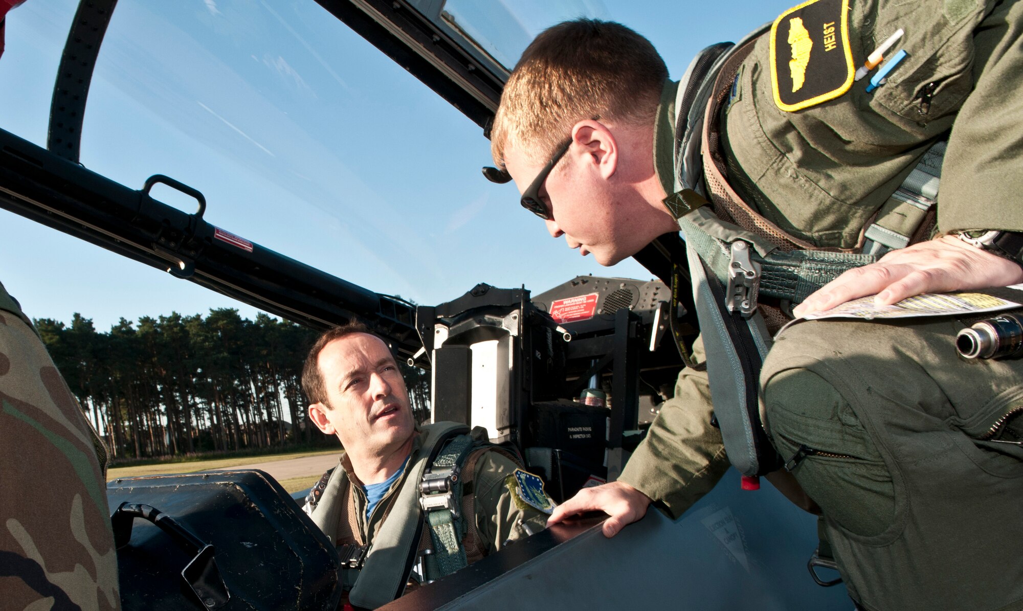 ROYAL AIR FORCE LAKENHEATH, England - Colin Wills (left), former 493rd Fighter Squadron honorary commander, receives instructions from Capt. Robert Hendrick, 493rd FS pilot, on different cockpit functions before their flight on an F-15D Eagle Sept. 7, 2012. Wills received an incentive flight with the 493rd FS to better understand the capabilities of the F-15 and to thank him for his service as the squadron’s honorary commander. (U.S. Air Force photo by Senior Airman Connor Estes)