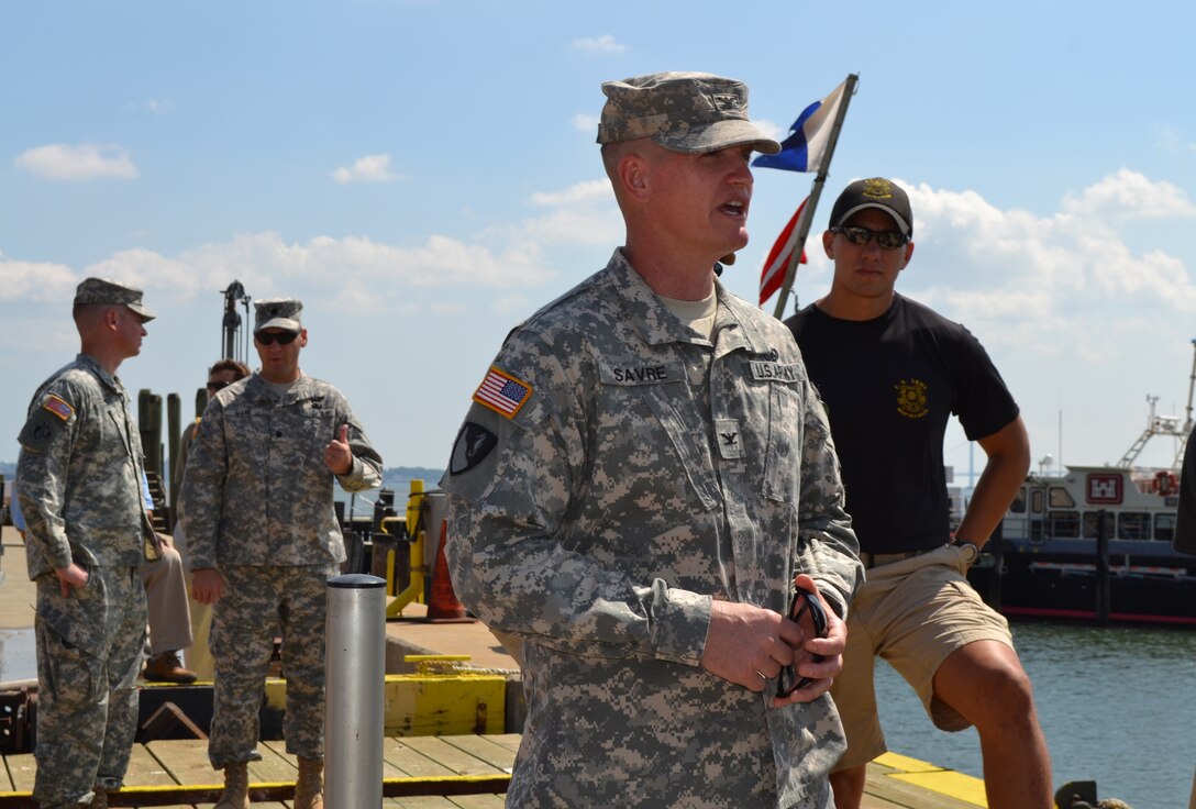 Col. Kent Savre, North Atlantic Division Commander, meets with divers from the 86th Engineer Dive Detachment at a U.S. Army Corps of Engineers office in Caven Point, NJ, August 28. The divers were conducting pier rehabilitation operations. Savre acknowledged their performance and conveyed his appreciation by presenting them with the Division Commander’s coin. 