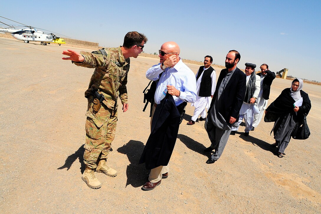 U.S. Navy Cmdr. Thomas Sheppard, left, welcomes distinguished visitors to a key leader engagement on Forward Operating Base Farah, in Afghanistan's Farah province, Sept. 10, 2012. Sheppard is the commanding officer of Provincial Reconstruction Team Farah.
