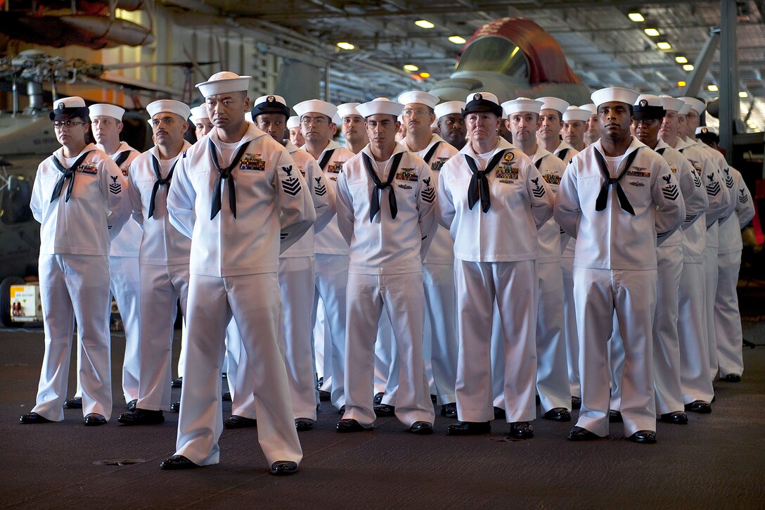 U.S. Navy Chief Petty Officer selectees stand at parade rest during a ceremony commemorating the 9/11 terrorist attacks aboard the USS Enterprise under way in the Arabian Sea, Sept. 11, 2012. 