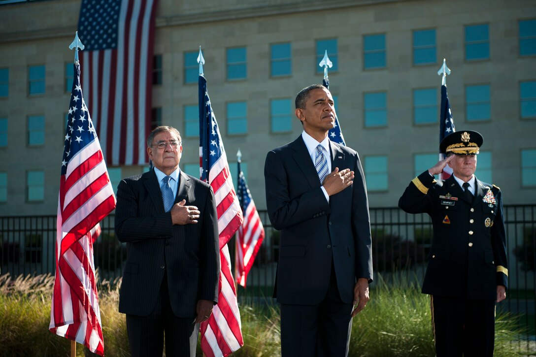 Defense Secretary Leon E. Panetta, President Barack Obama and Army Gen. Martin E. Dempsey, chairman of the Joint Chiefs of Staff, render honors as the national anthem plays during a ceremony to commemorate the 11th anniversary of the 9/11 terrorist attacks at the Pentagon, Sept. 11, 2012.