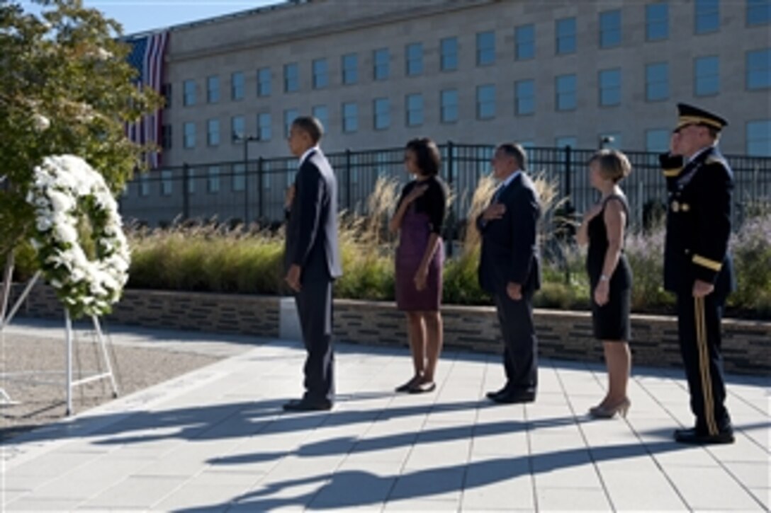 President Barack Obama, left, First Lady Michelle Obama second from left, Secretary of Defense Leon E. Panetta third from left, Deanie Dempsey fourth from left, and Chairman of the Joint Chiefs of Staff Gen. Martin E. Dempsey salute as a bugler plays Taps at a wreath laying commemorating the 11th anniversary of the Sept. 11, 2001, terrorist attacks on the Pentagon on Sept. 11, 2012.  