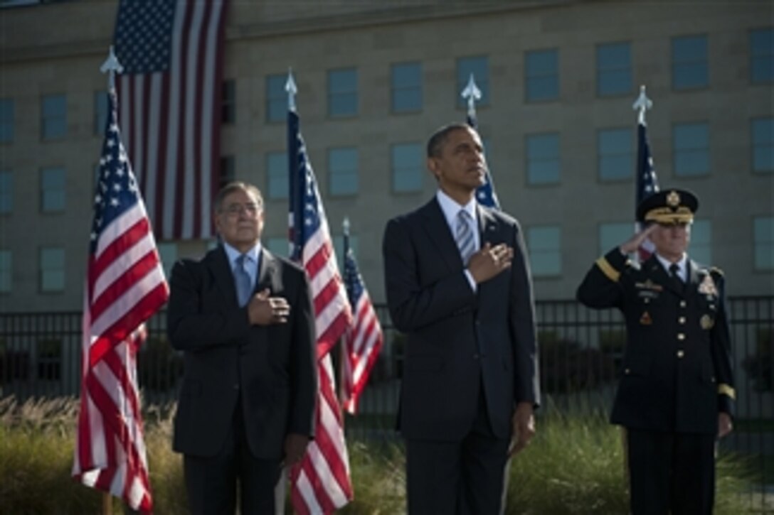 Secretary of Defense Leon E. Panetta, left, President Barack Obama, center, and Chairman of the Joint Chiefs of Staff Gen. Martin E. Dempsey render honors during the playing of the National Anthem during a ceremony commemorating the 11th anniversary of the Sept. 11, 2001, terrorist attacks on the Pentagon on Sept. 11, 2012. 