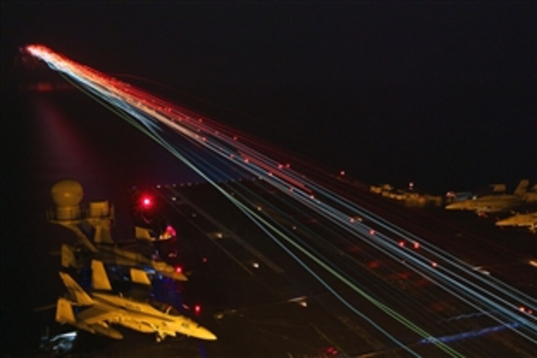 U.S. Navy aircraft land aboard the aircraft carrier USS Enterprise during nighttime flight operations while under way in the Arabian Sea, Sept. 8, 2012. The Enterprise is deployed to the U.S. 5th Fleet area of responsibility conducting maritime security operations, theater security cooperation efforts and support missions as part of Operation Enduring Freedom.