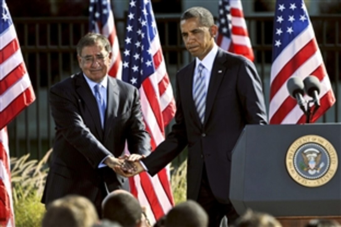President Barack Obama shakes hands with Defense Secretary Leon E. Panetta during a ceremony to commemorate the 11th anniversary of the 9/11 terrorist attacks at the Pentagon, Sept. 11, 2012. 