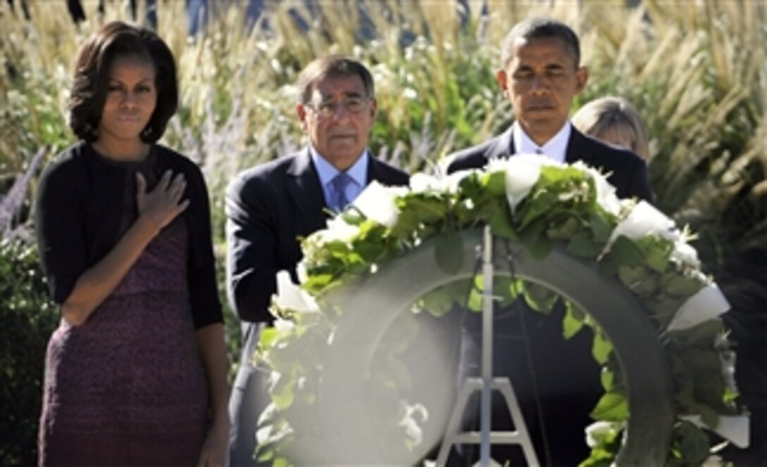 President Barack Obama, right, Secretary of Defense Leon E. Panetta, center, and First Lady Michelle Obama observe a moment of silence after the president laid a wreath at a ceremony commemorating the 11th anniversary of the Sept. 11, 2001, terrorist attacks on the Pentagon on Sept. 11, 2012.  