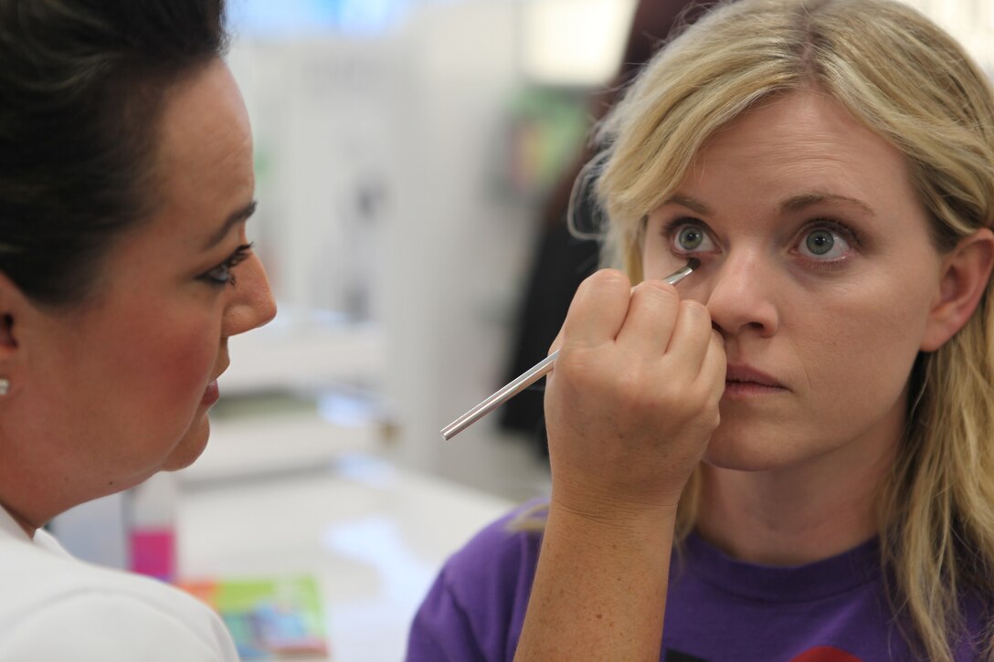 A customer has make-up applied to her eyes by Brenda Leiva, a representative of a cosmetics company of Marine Corps Base Camp Lejeune's Marine Corps Exchange Sept. 7. Employees of the cosmetics department give free demonstrations and teach customers makeup techniques.
