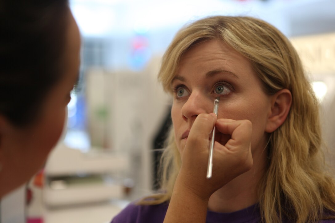 A customer has make-up applied to her eyes by Brenda Leiva, a representative of a cosmetics company of Marine Corps Base Camp Lejeune's Marine Corps Exchange Sept. 7. Employees of the cosmetics department give free demonstrations and teach customers makeup techniques. 