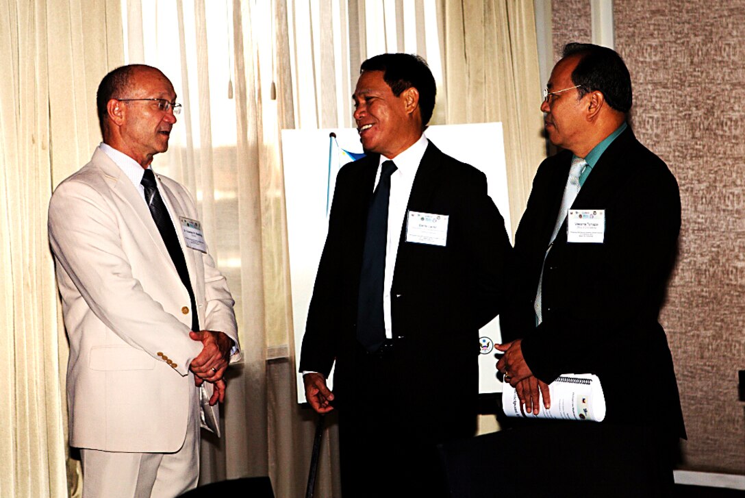 Charles W. Beadling, left, director of the Center for Disaster and Humanitarian Assistance Medicine, greets Dante Lantin, (center) assistant secretary of the Philippine Department of Transportation and Communications, and Vincente F. Tomazar, director of Region 4A, Office of Civil Defense, during the Philippine Multi-sectoral Pandemic Disaster Exercise held in Makati, Philippines, Sept. 10. As with other bilateral exchanges, this event reinforces the mutual commitment shared between the Philippines and the U.S. to enhancing the effective response capabilities to regional threats.