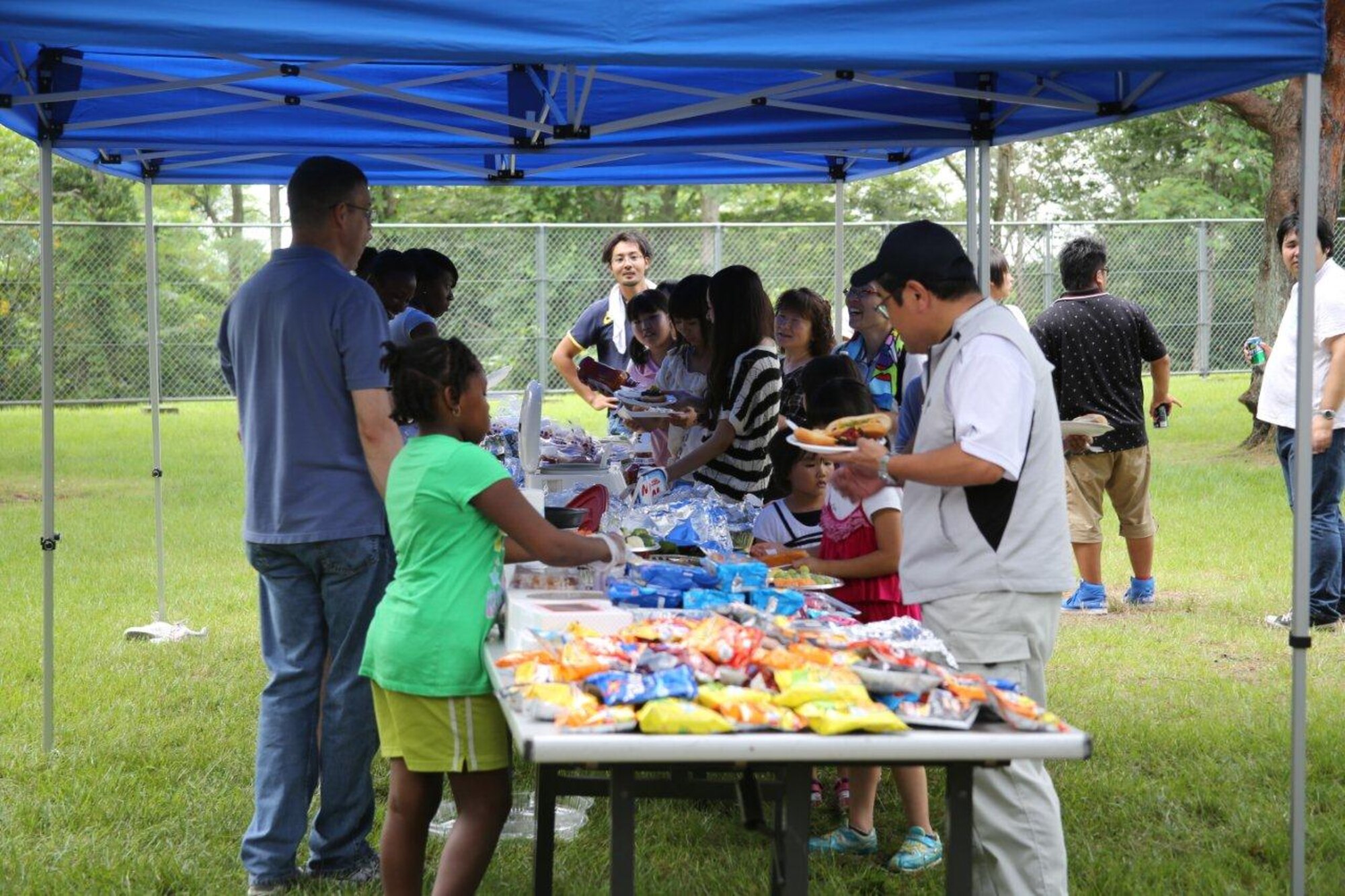 Members of the 35th Logistics Readiness Squadron treat children from Fuji Seiboen Orphanage to American cuisine at Leftwich Park in Aomori, Japan on Aug. 18, 2012. The 35 LRS invited the children to their annual squadron picnic and 85 children joined in food and games. (Courtsey photo/Released)